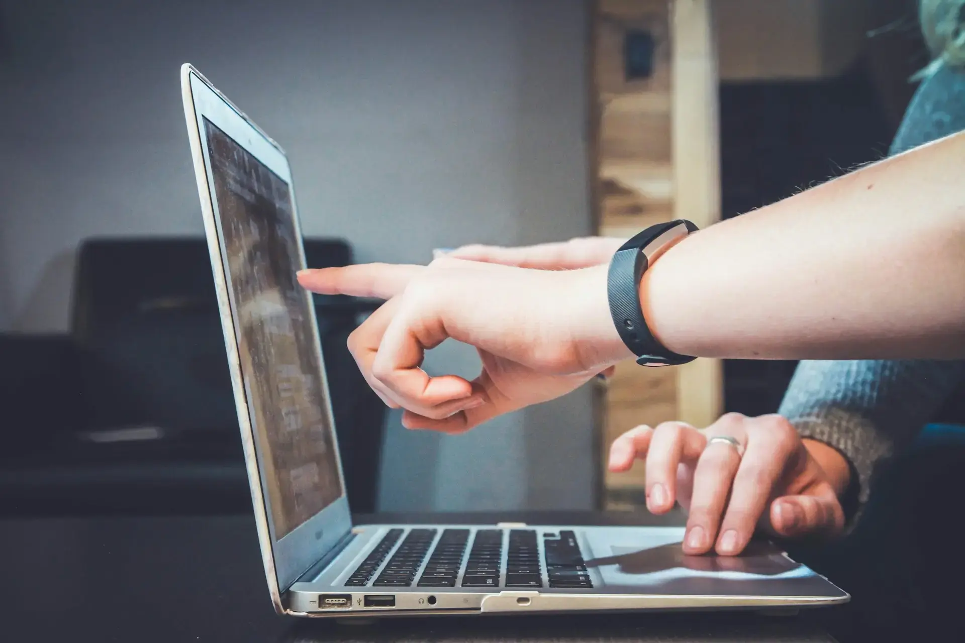 People pointing at a computer screen